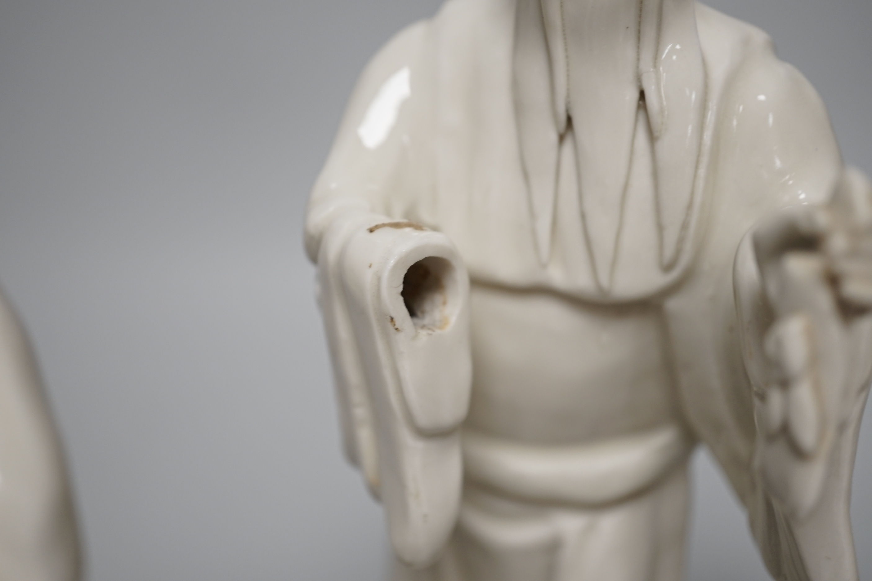 Seven Chinese blanc de Chine figures of immortals, each raised on carved hardwood bases, the largest 24cm high